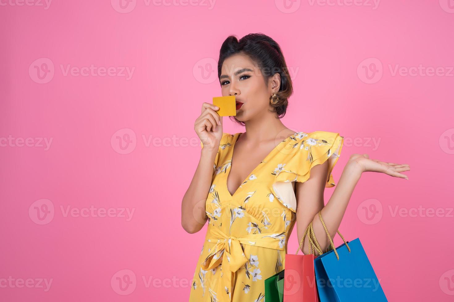 Fashionable woman with shopping bags and credit card photo