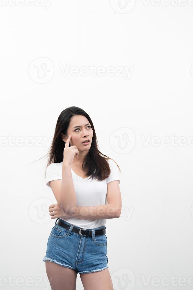 Portrait of a beautiful young woman thinking isolated on white background photo