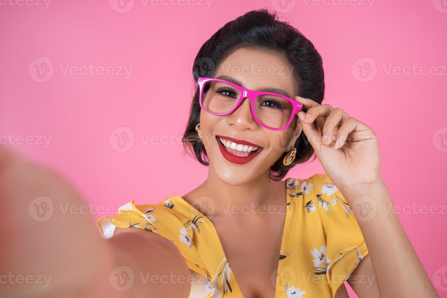 Beautiful fashionable woman taking a selfie with her phone photo