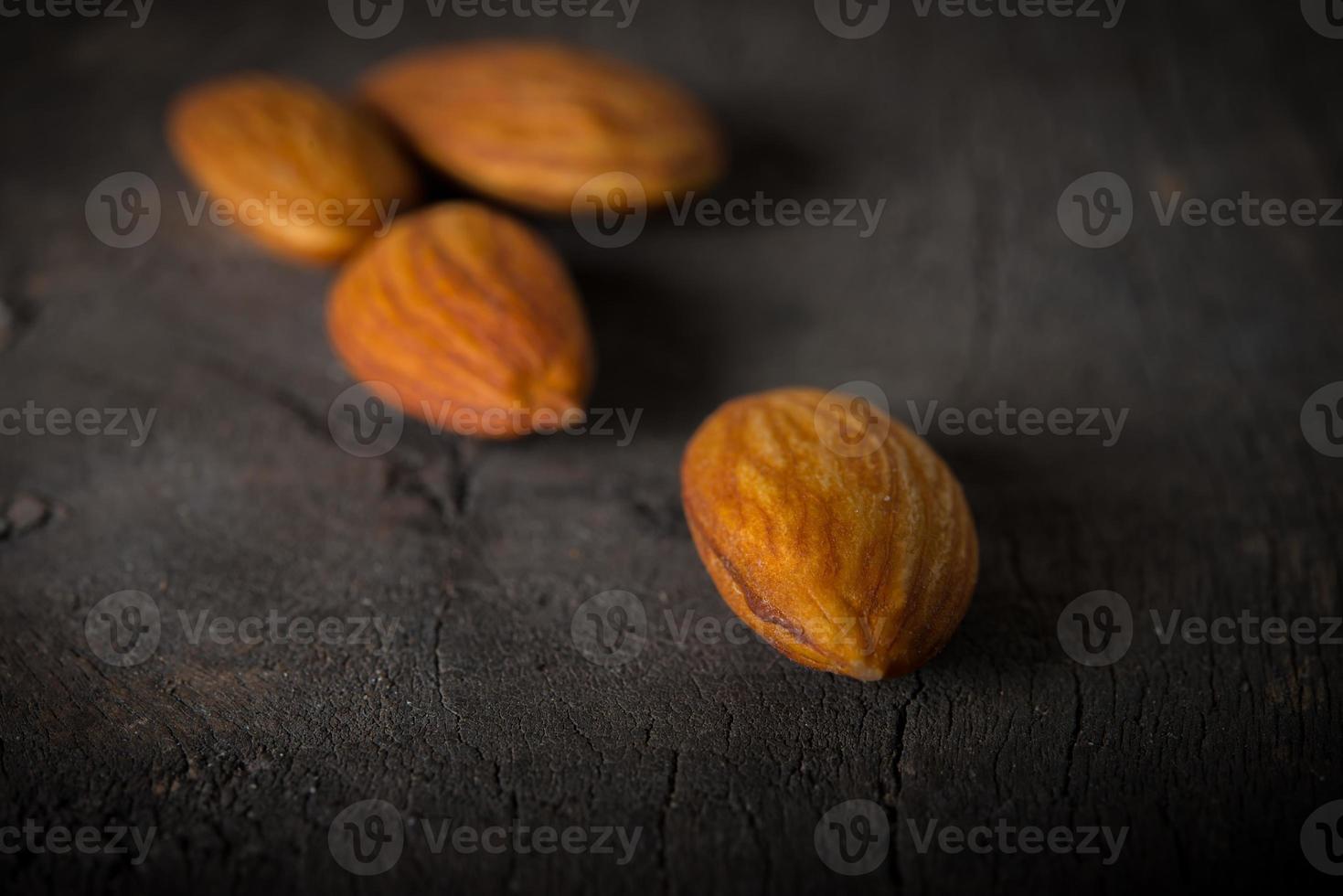 Almonds on wooden background photo