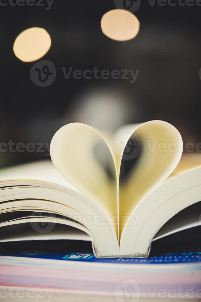 Curled paper heart shape with blurred bokeh of cafe photo