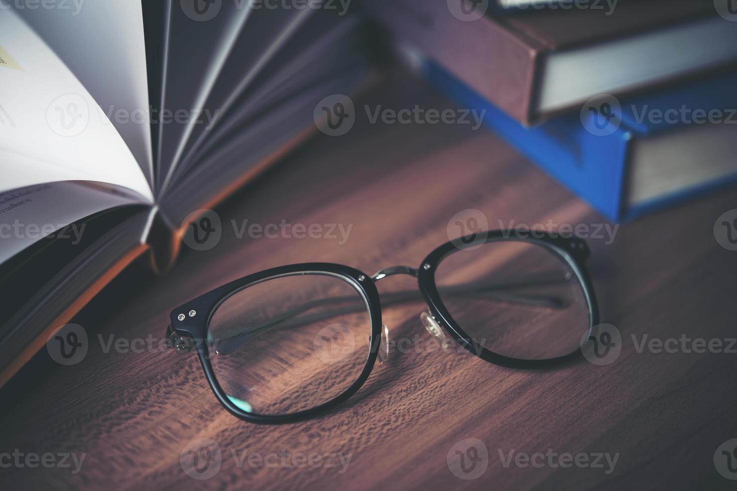 Glasses on wooden table with book photo