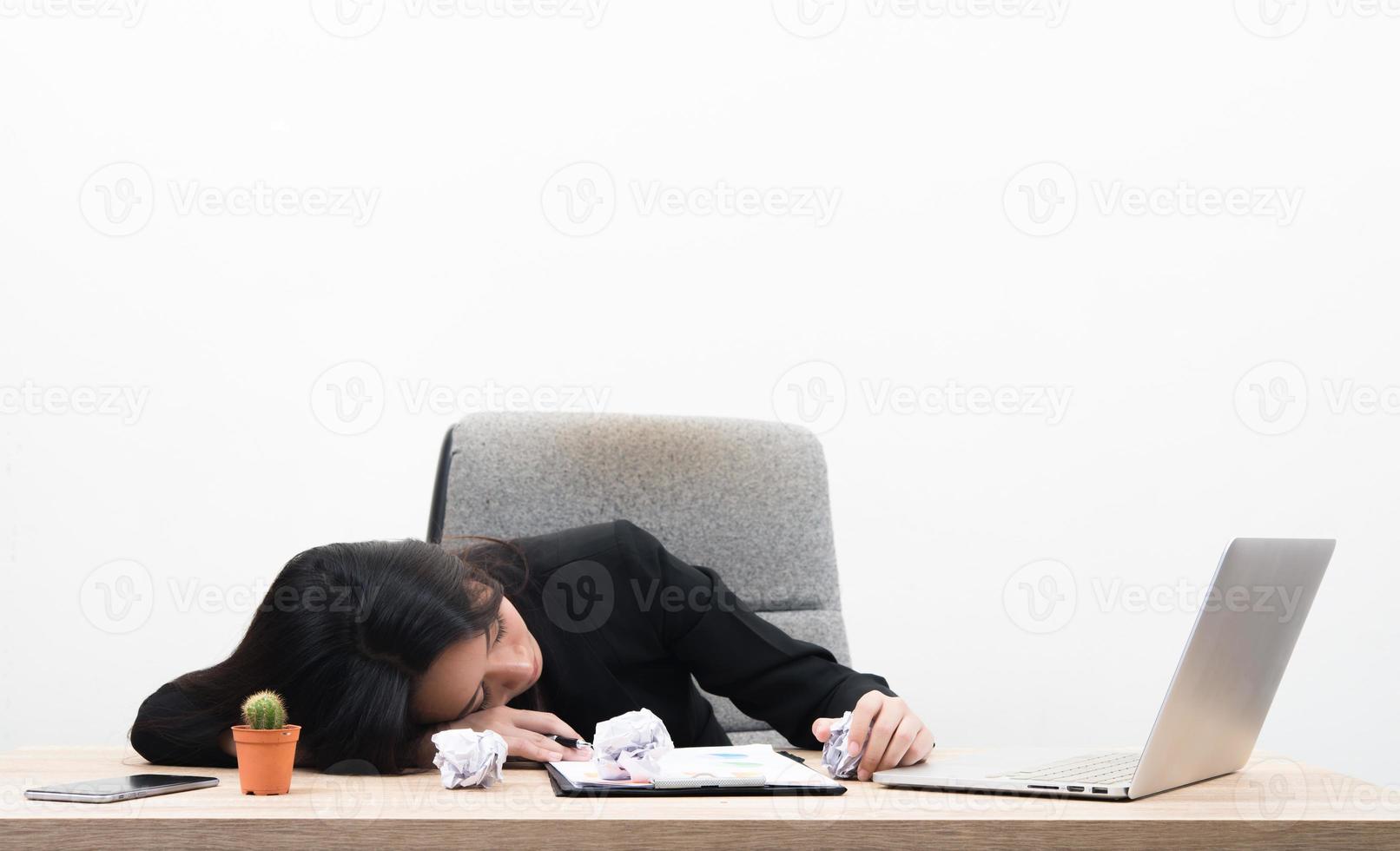 Tired overworked young business woman sleeps in office at workplace photo