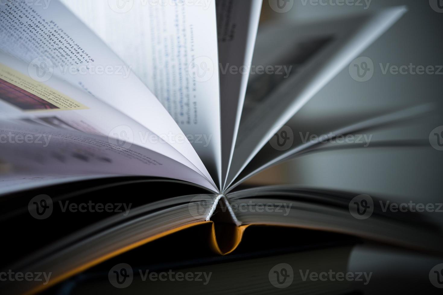 Close-up of opened book on wooden table photo