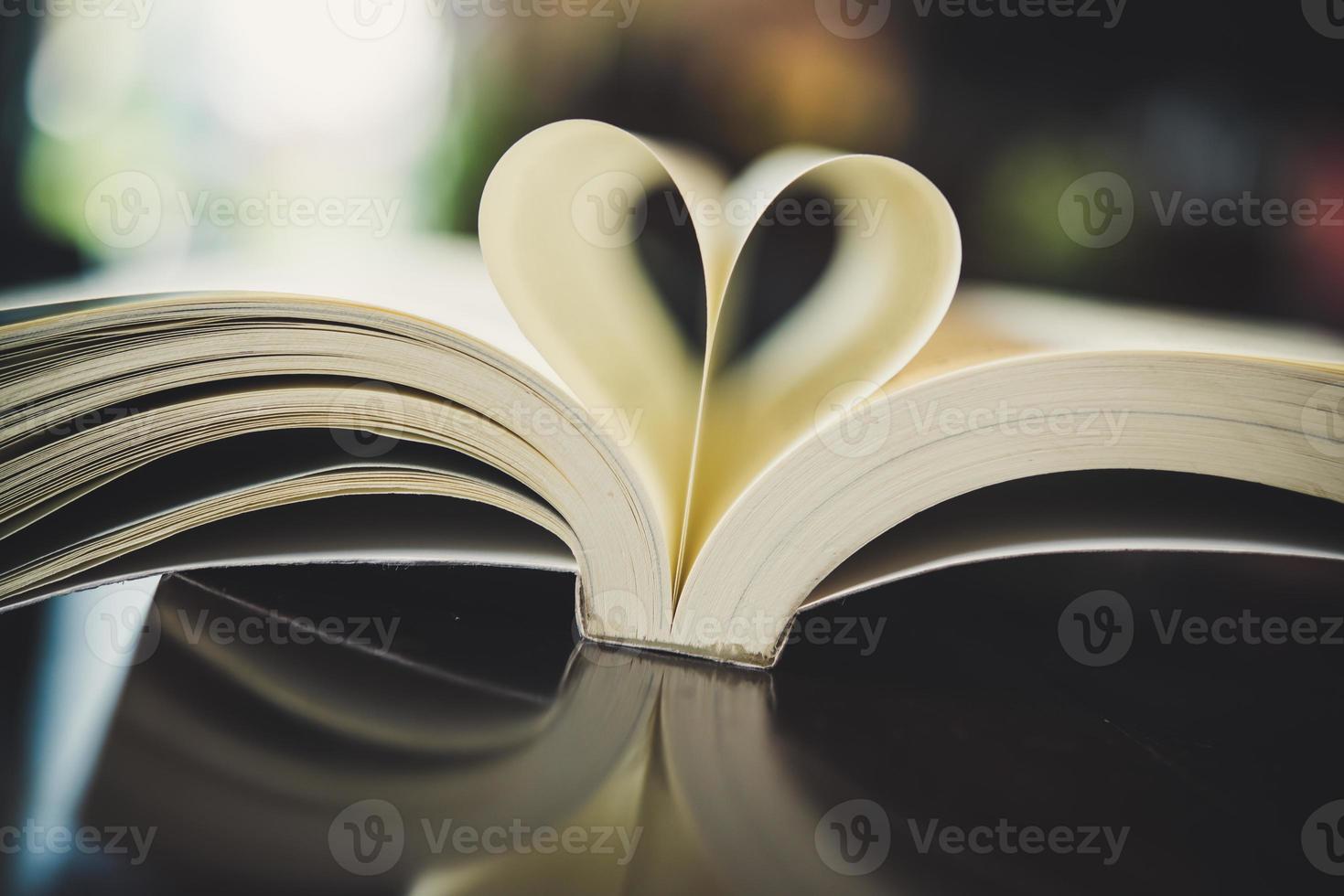 Curled paper heart shape with blurred bokeh of cafe photo