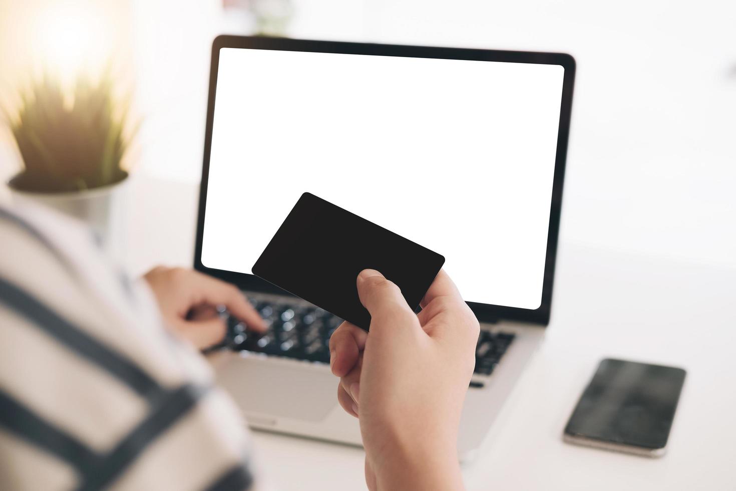 Woman's hands holding a credit card for online shopping photo