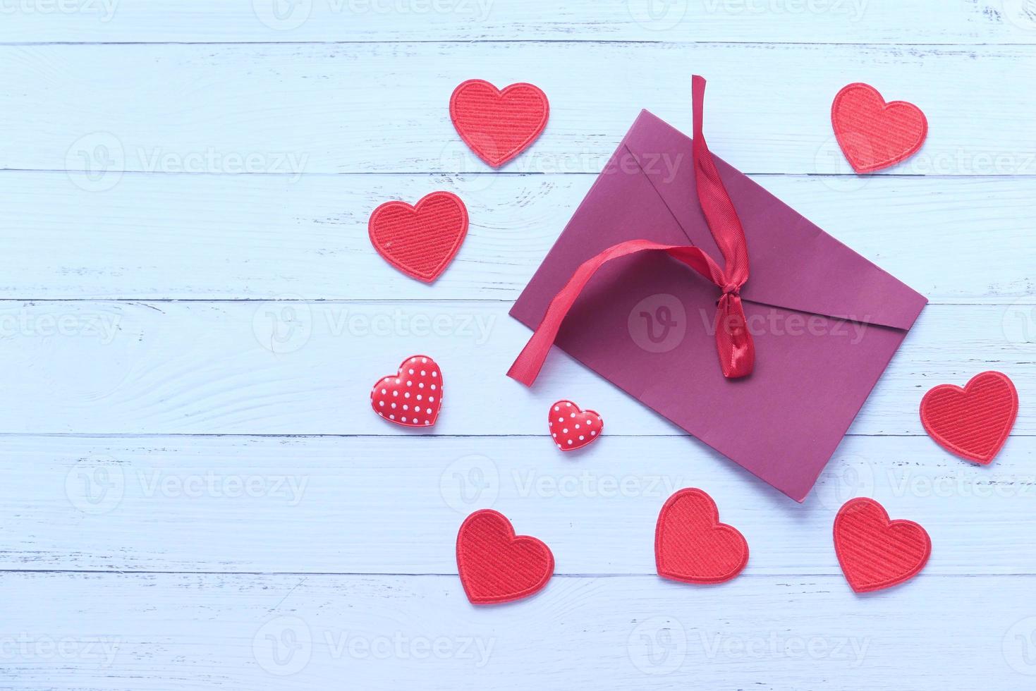 Red envelope and red heart on white background photo