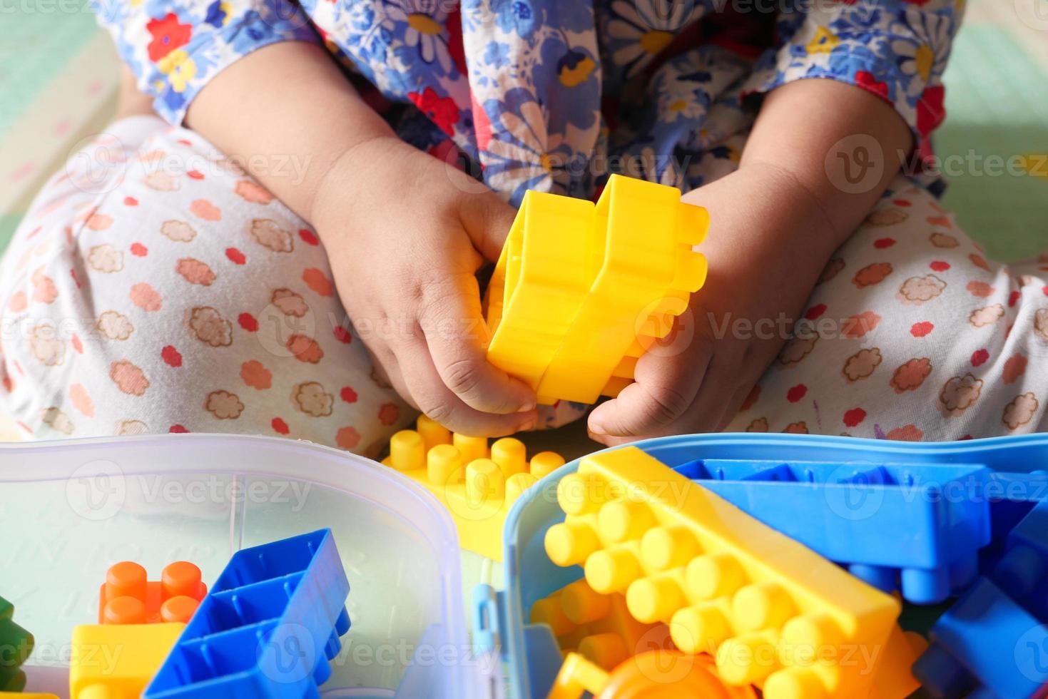 Child playing with building blocks photo