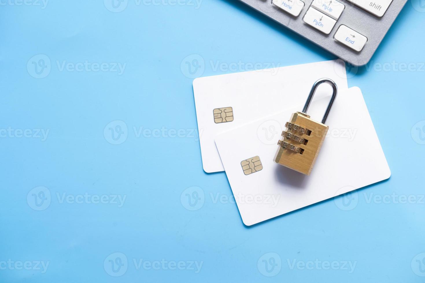 Padlock with credit cards on blue background photo