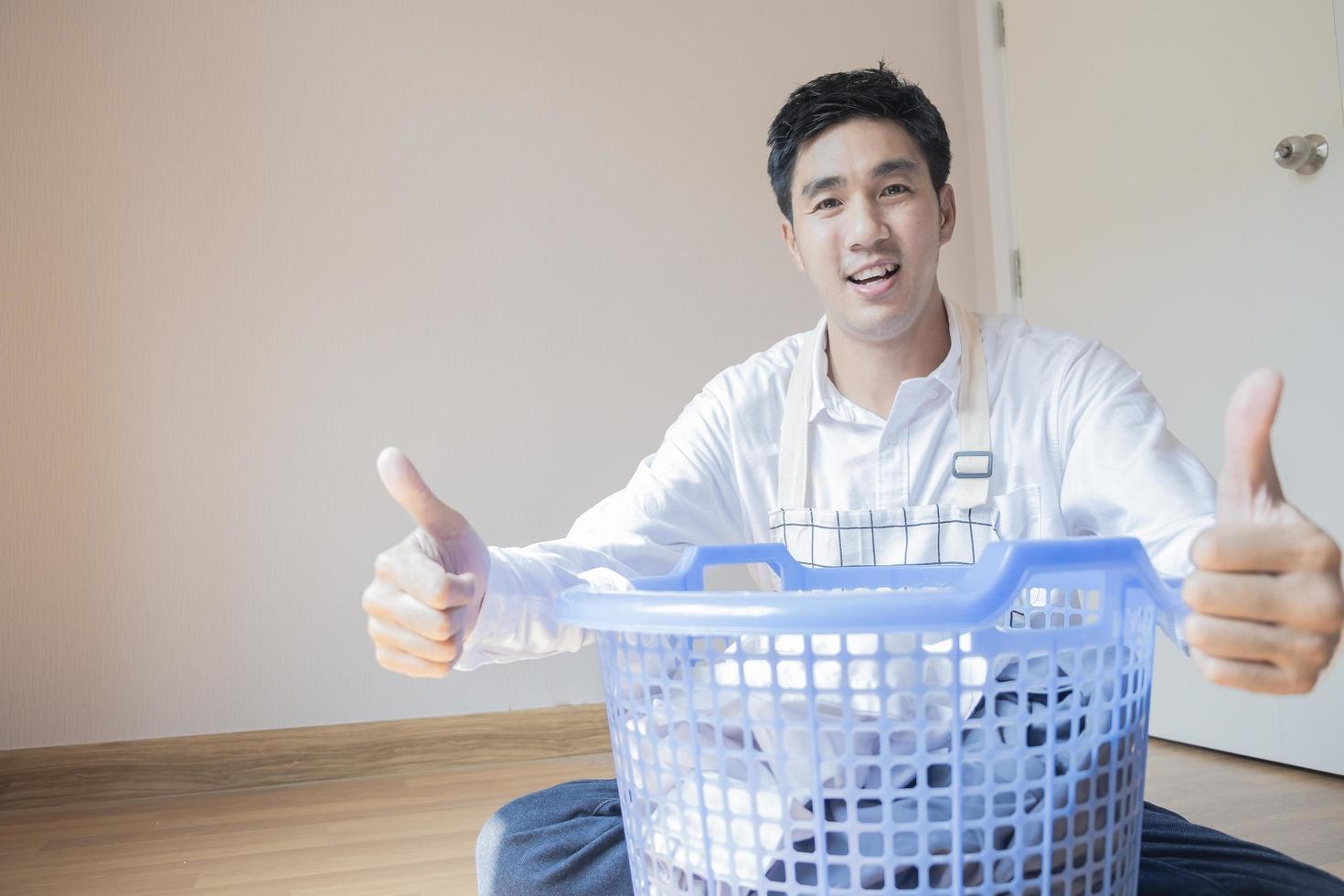 Asian man folding laundry photo