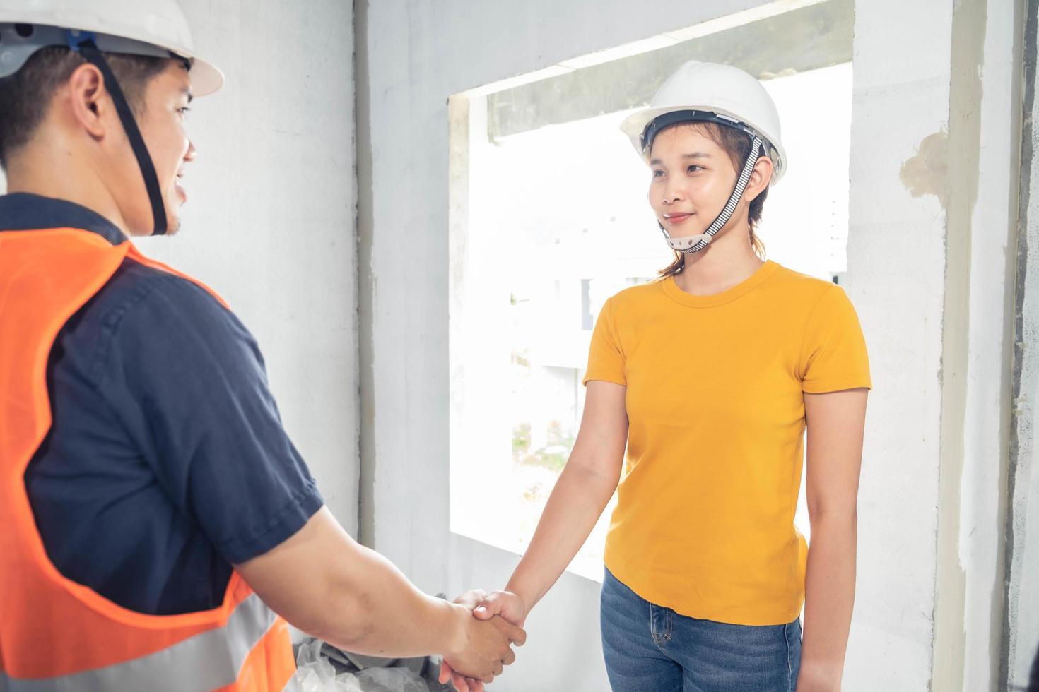 Young Asian engineers building a house photo