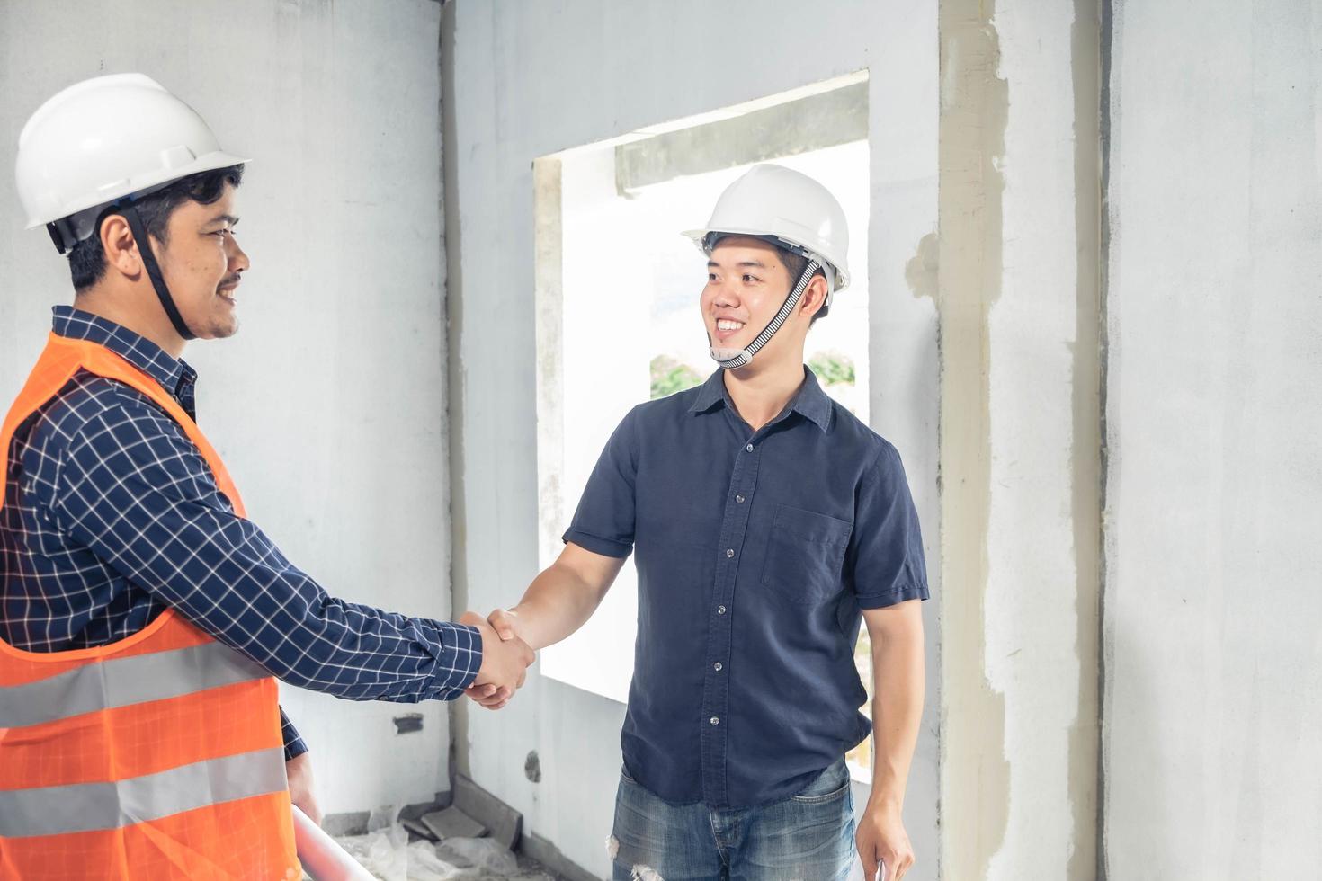 Young Asian engineers building a house photo