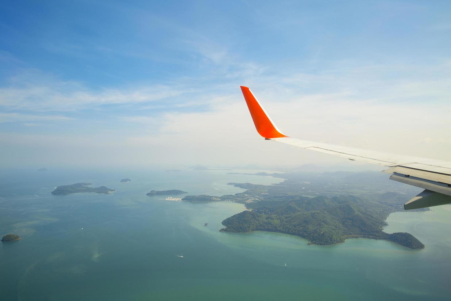 Aerial view of plane wing over Phucket Island, Thailand photo