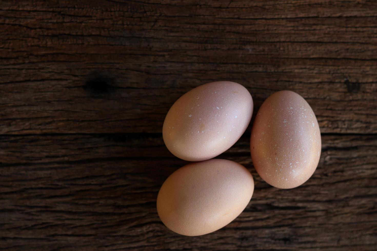 Hen eggs on wood background photo