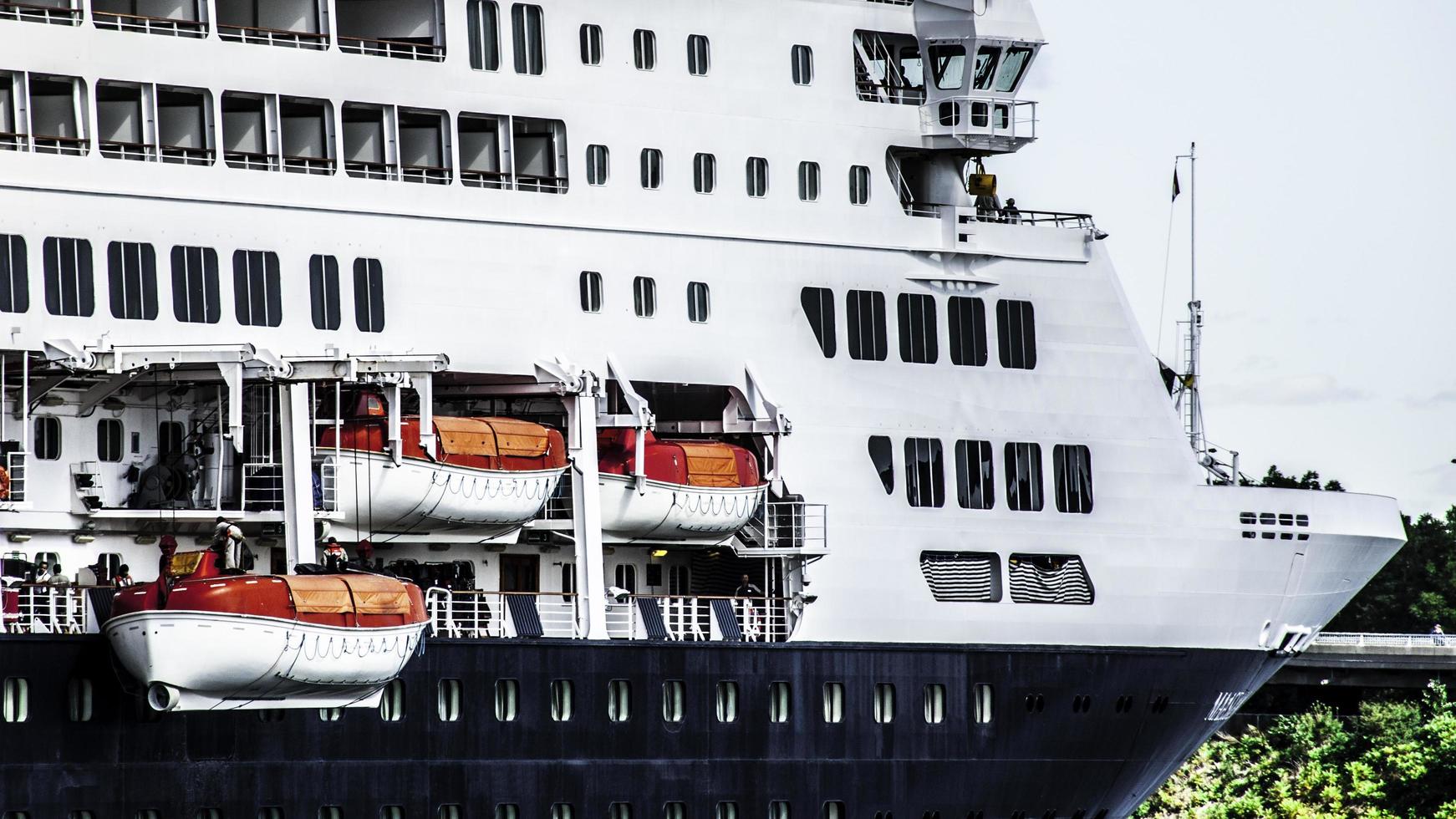 People working on the side of a cruise liner ship photo