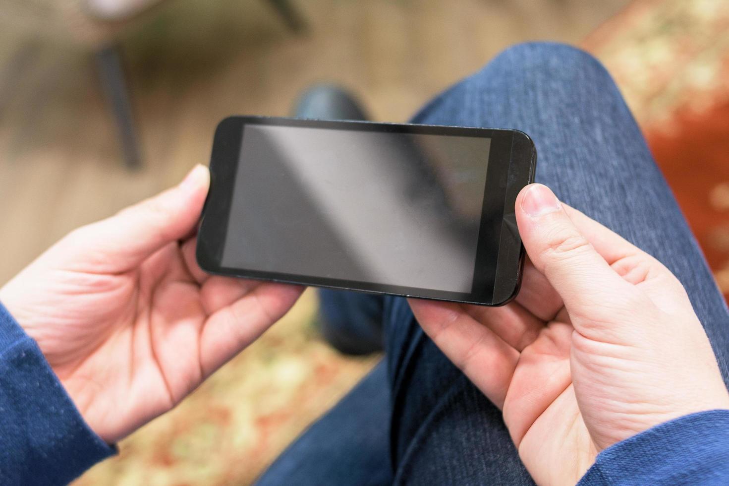 Close up of a man holding a mobile smartphone photo