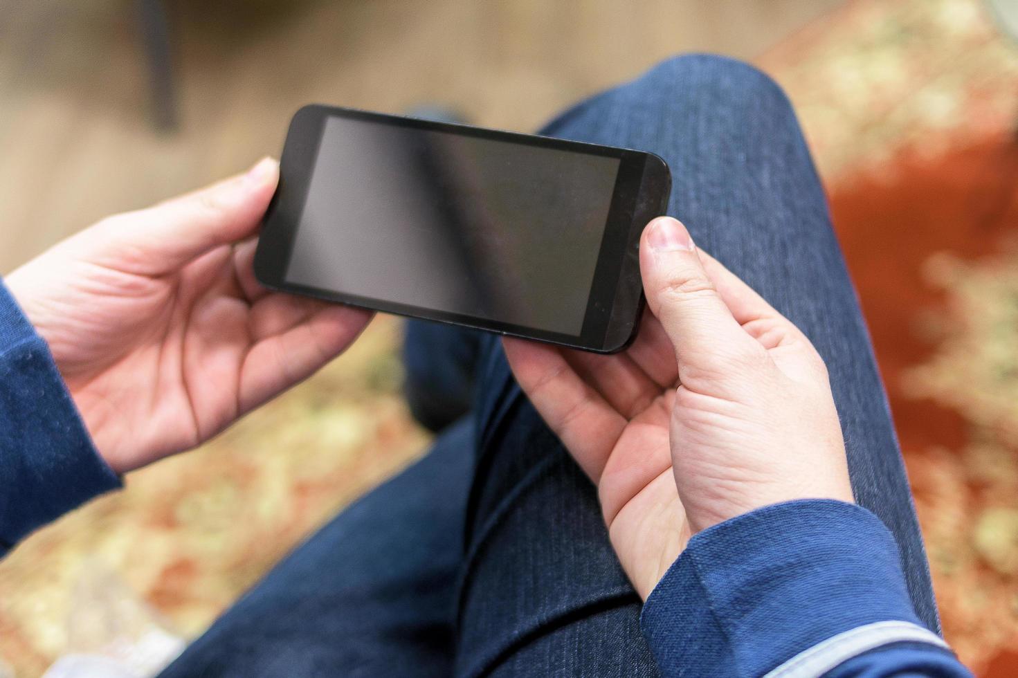 Close up of a man holding a mobile smartphone photo