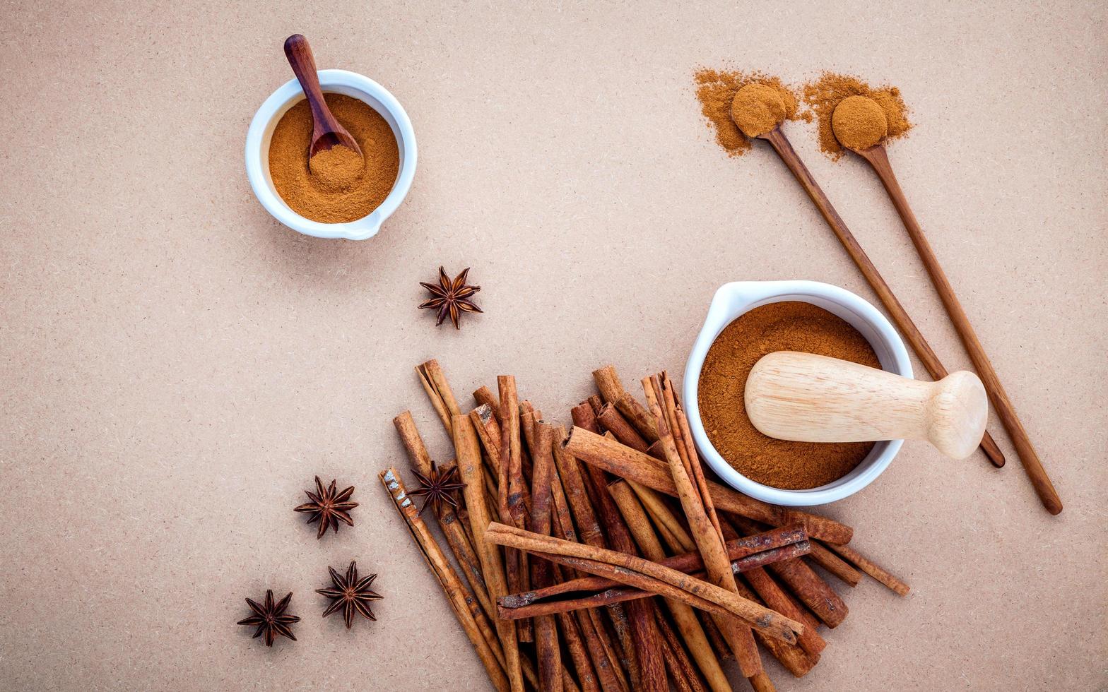 Cinnamon and anise on a brown background photo