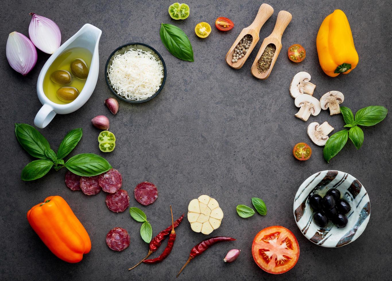 Pizza ingredients on dark slate photo