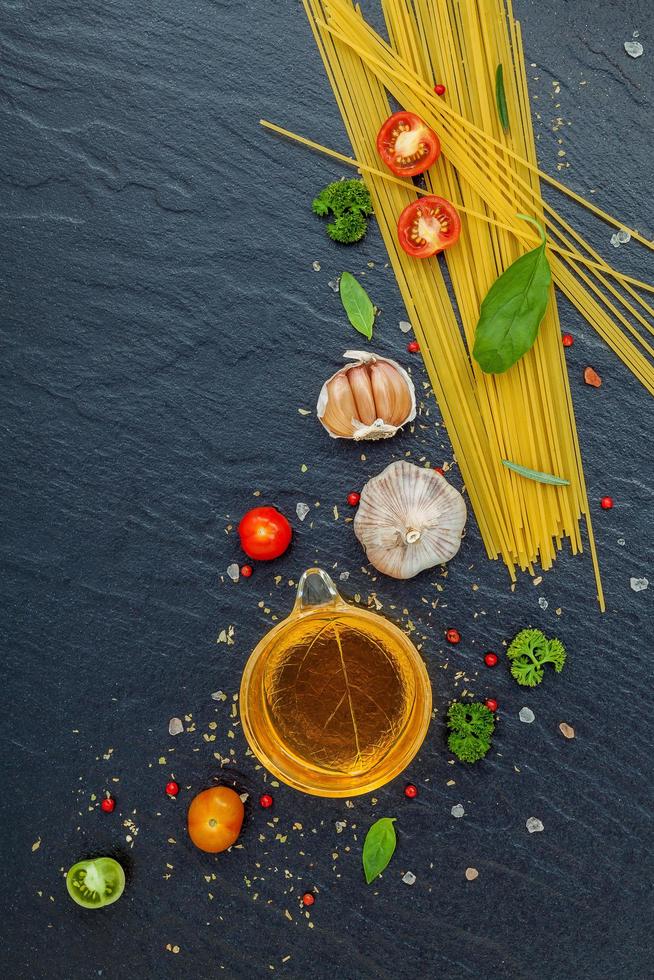 Fresh spaghetti ingredients on a dark background photo