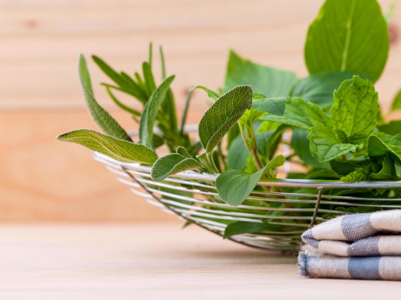 Bowl of fresh herbs on a table photo