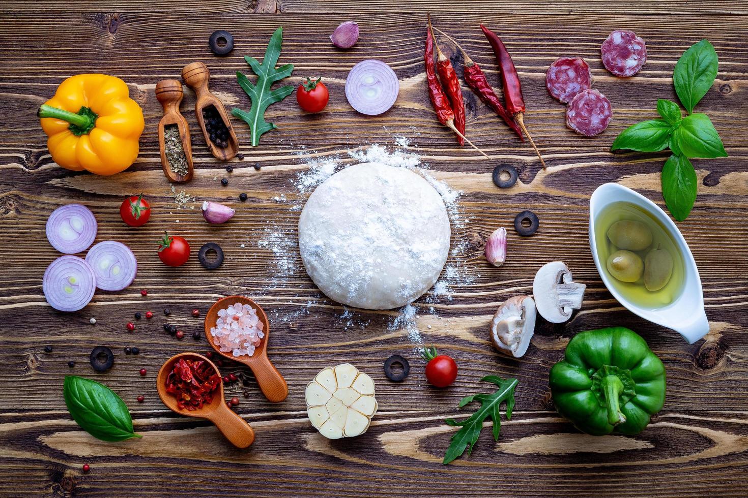 Top view of pizza dough and toppings photo