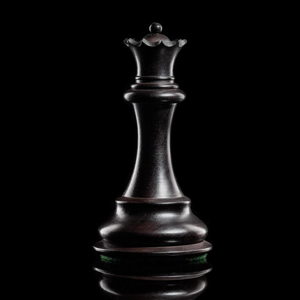 Black queen chess piece on a dark background photo