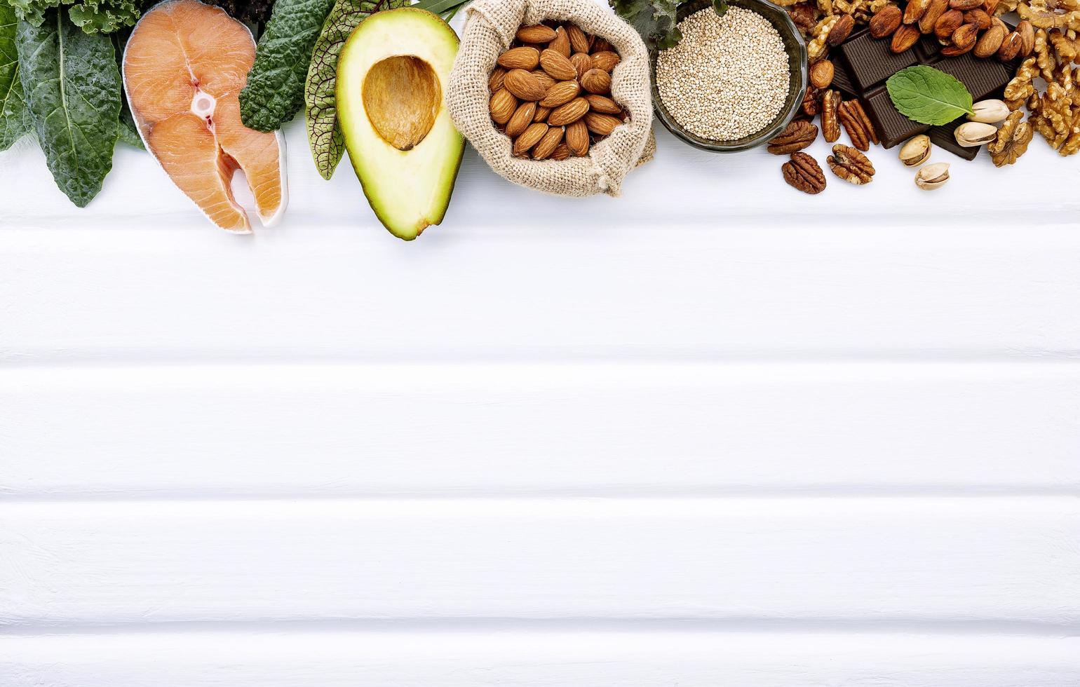 Border of fresh foods with copy space on white wood photo