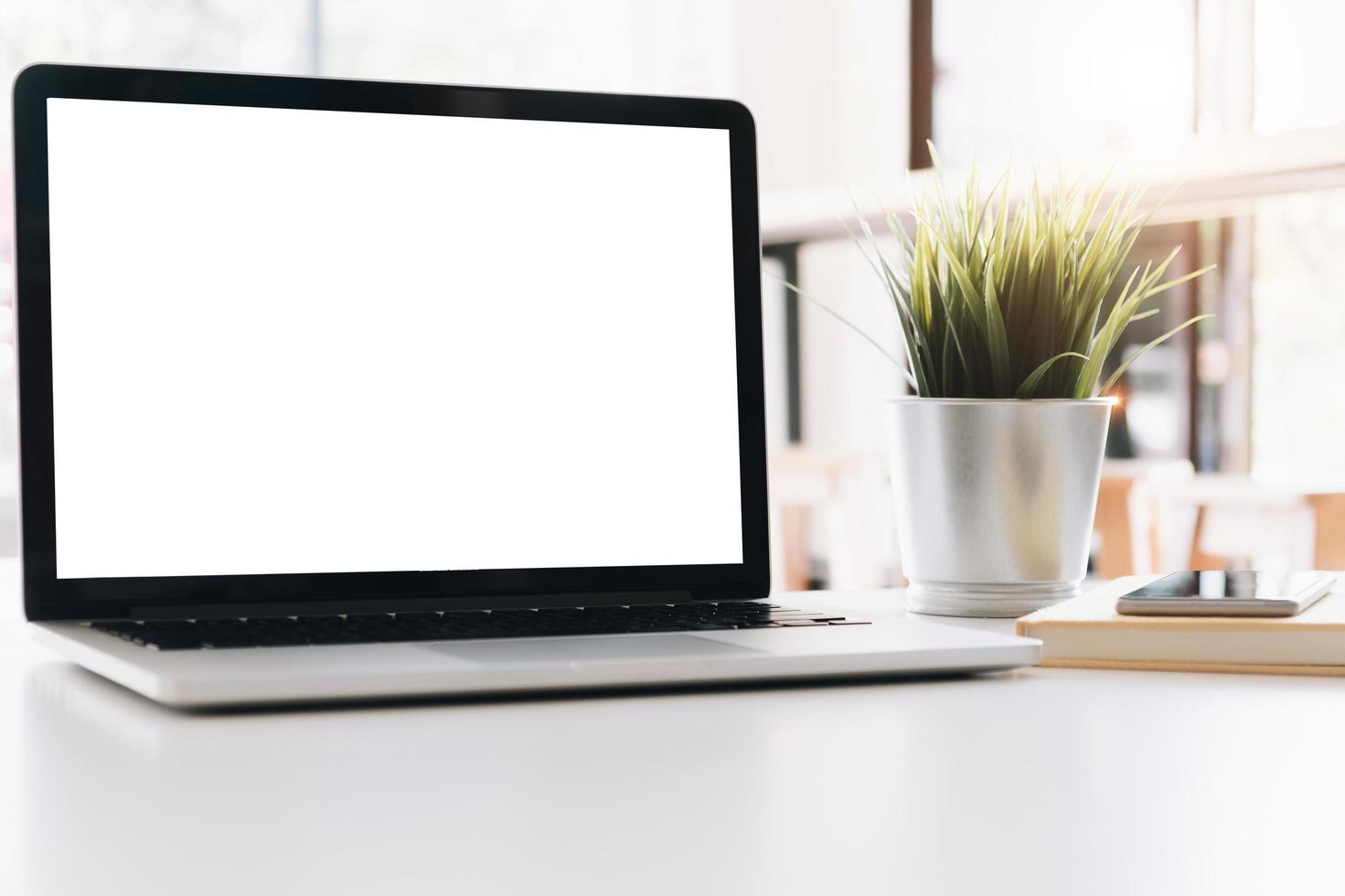 Mockup blank screen laptop on workspace photo