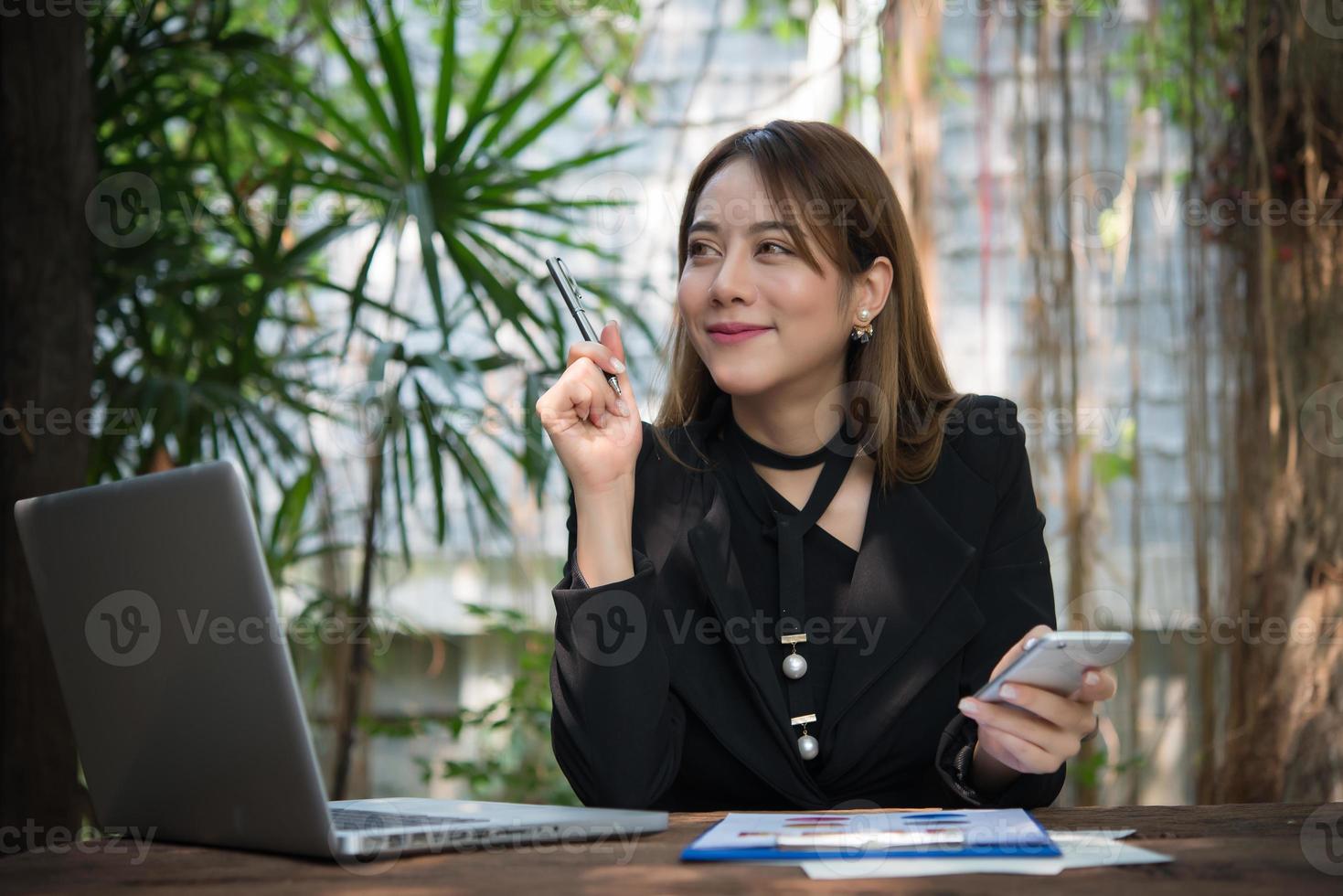 Executive thinking over working schedule while using laptop computer photo