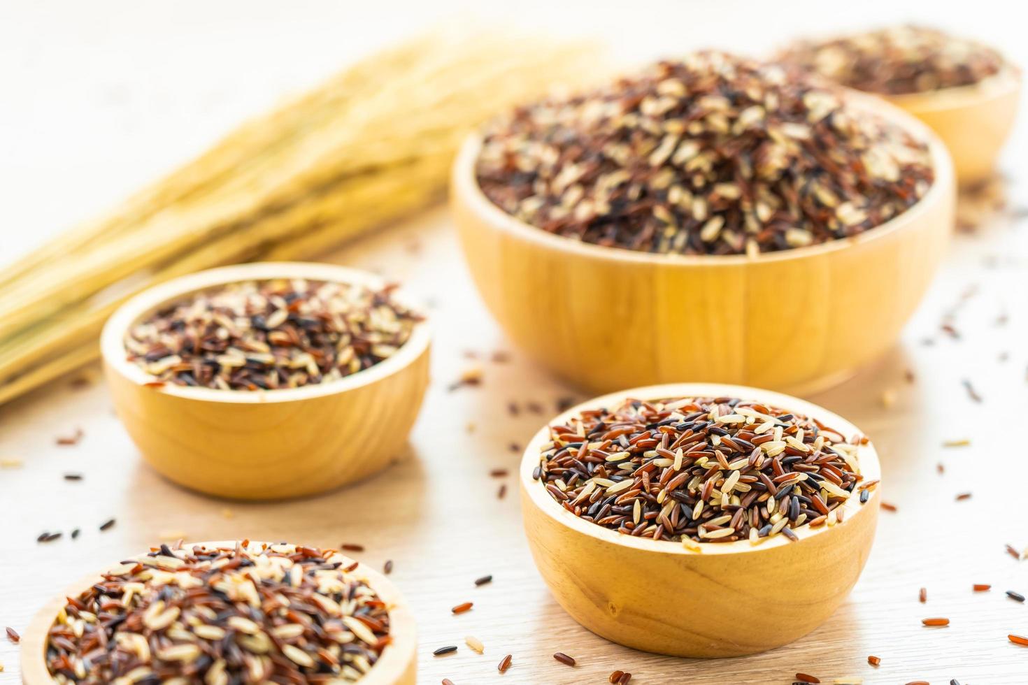 Raw brown rice in wooden bowl photo