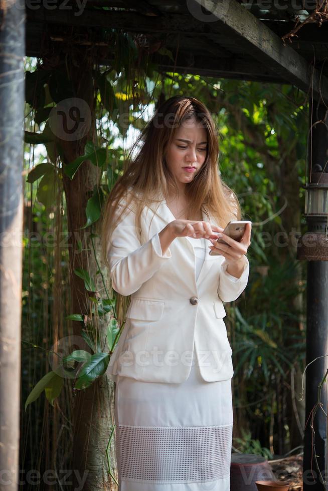 Young businesswoman looking at phone stressed out before work photo