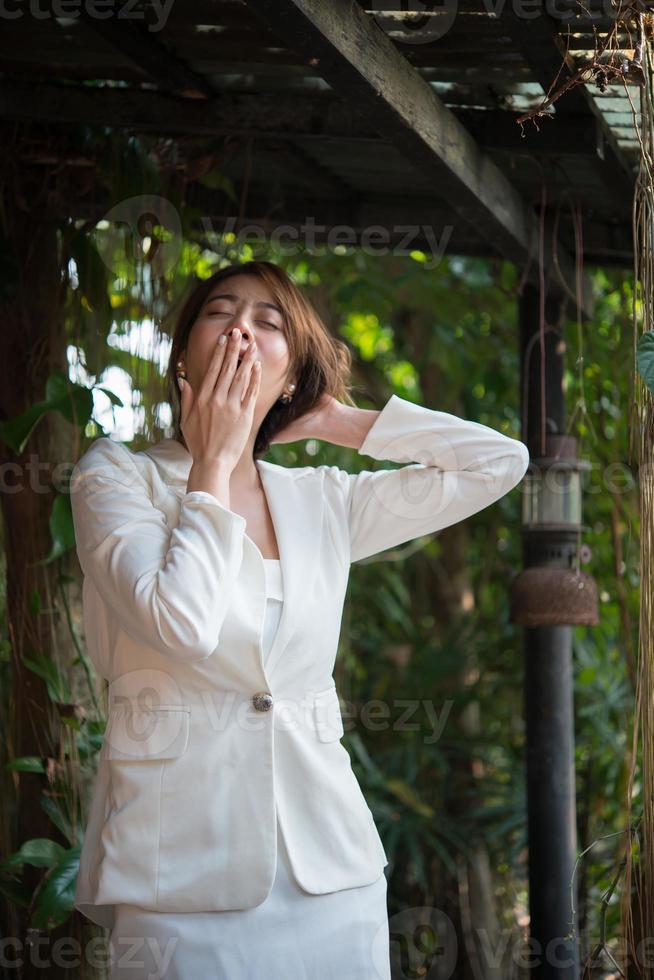 Young businesswoman stretching herself and yawning photo