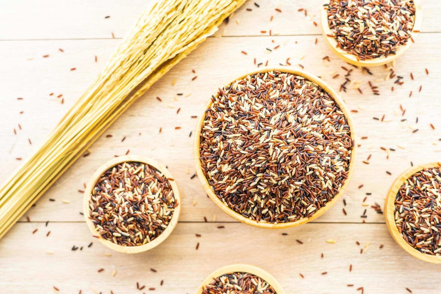 Raw brown rice in wooden bowl photo