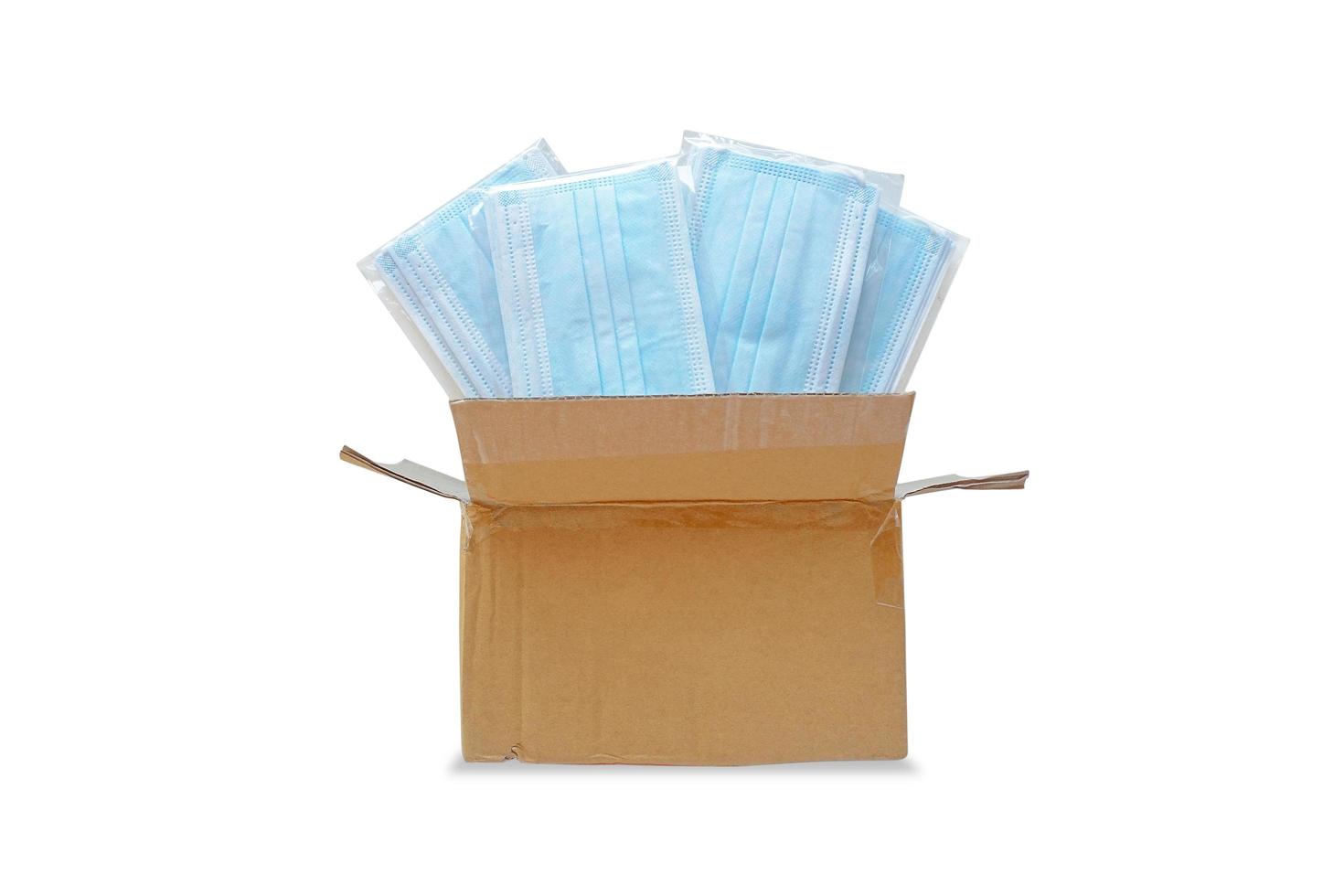 Box full of blue face masks isolated on white background with clipping path photo