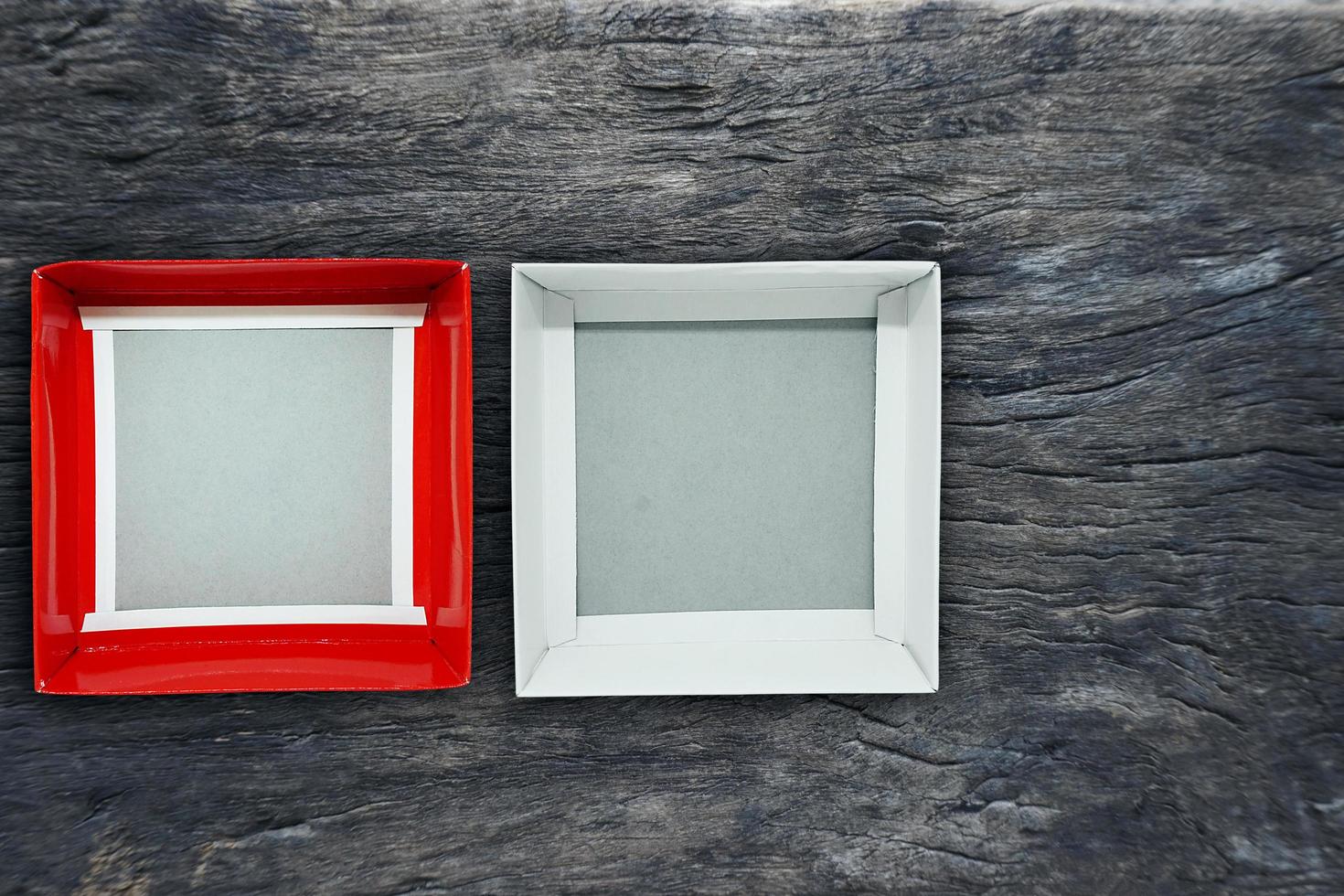 Top view of open blank box in red and white on wood background photo