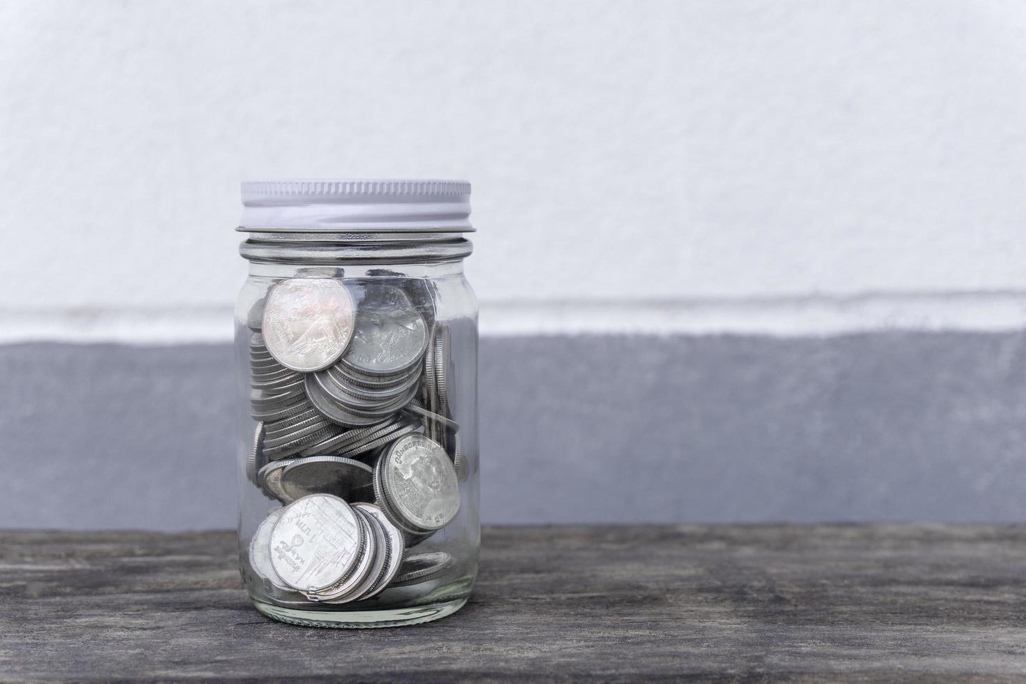 Coins in a bottle glass with filter effect photo