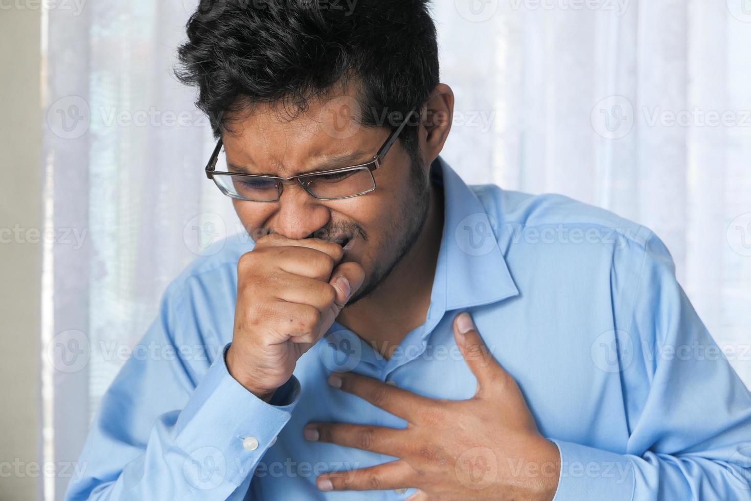 Young man coughing photo