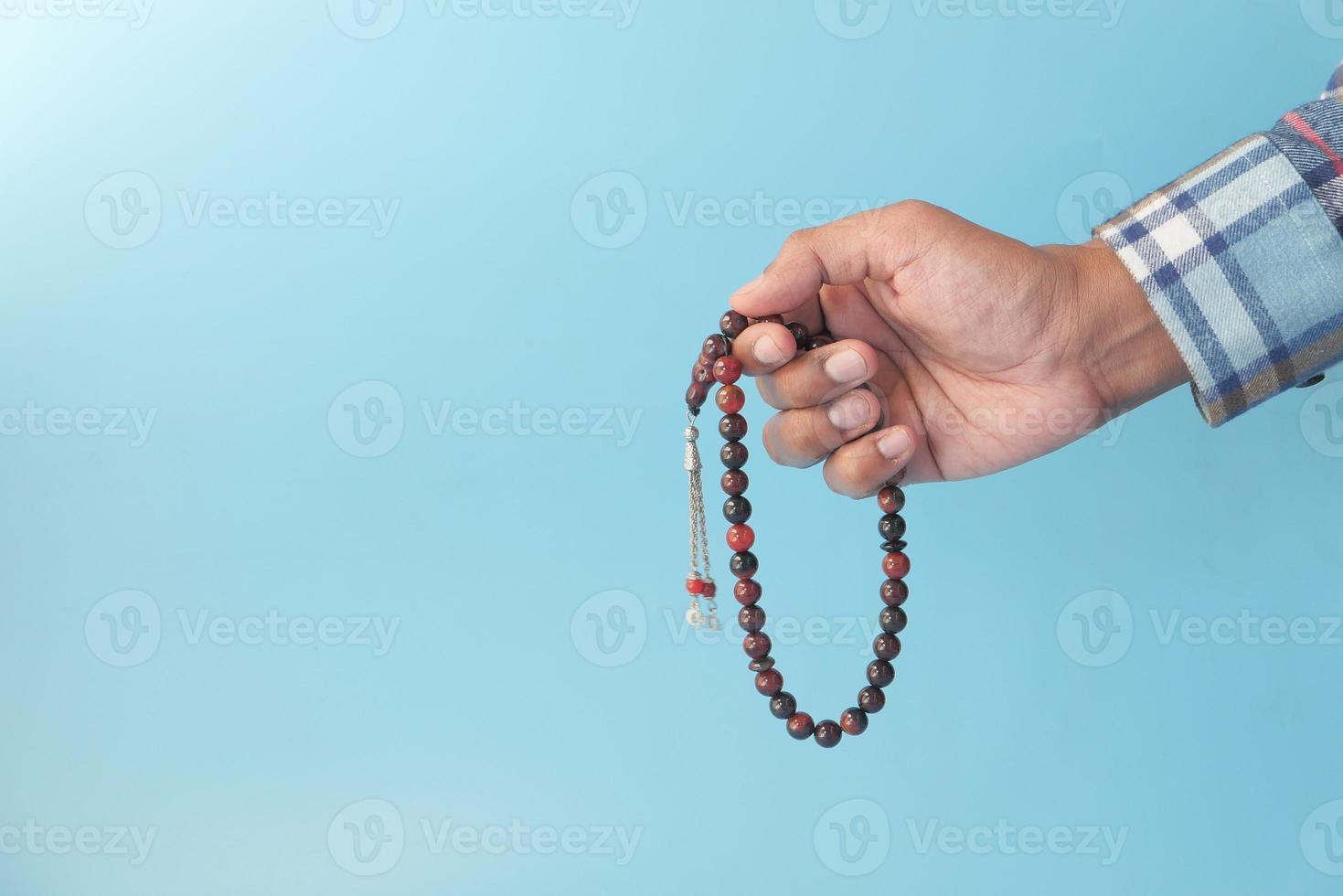 Prayer beads on blue background photo