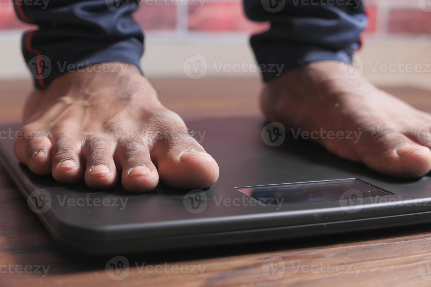 Man's feet on a scale photo