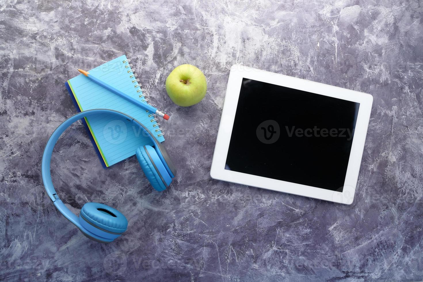 Headphones and digital tablet on table photo