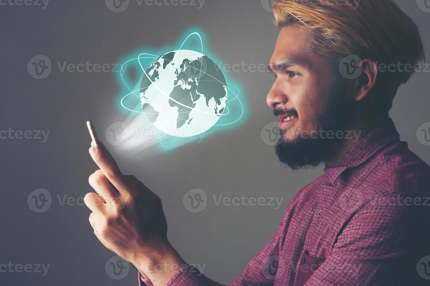 Businessman using global network and data exchanges with a mobile phone photo