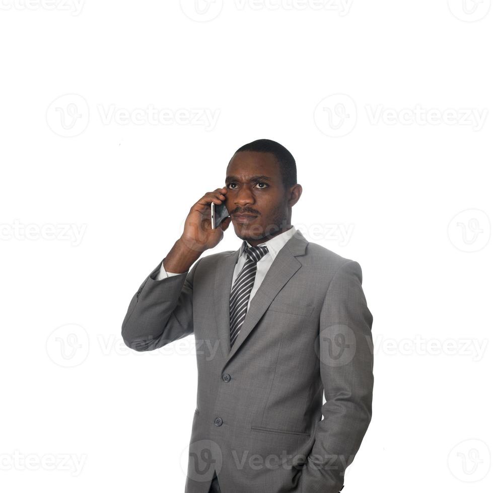 Young entrepreneur talking on cell phone isolated on white backkground photo