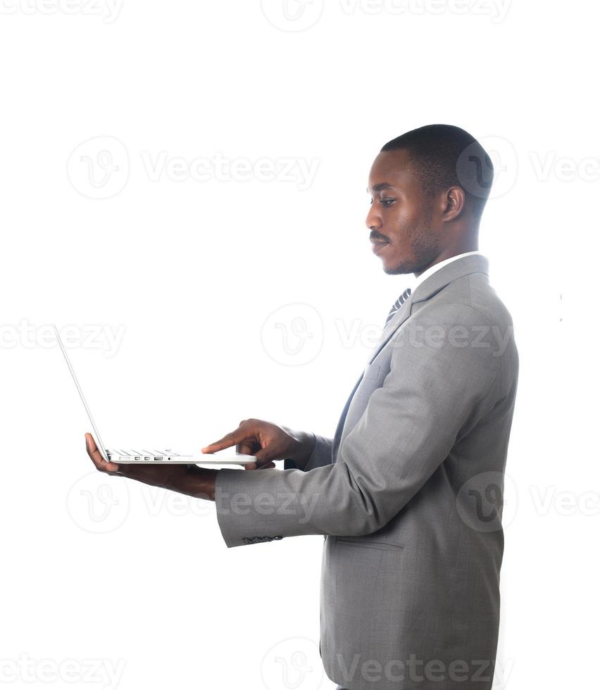 Joven empresario trabajando con un portátil aislado sobre fondo blanco. foto