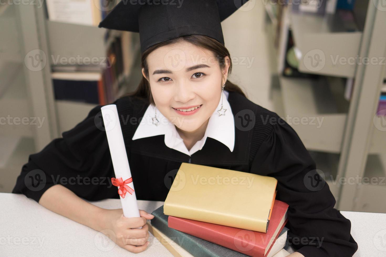 Happy graduate student holding a diploma in hand photo