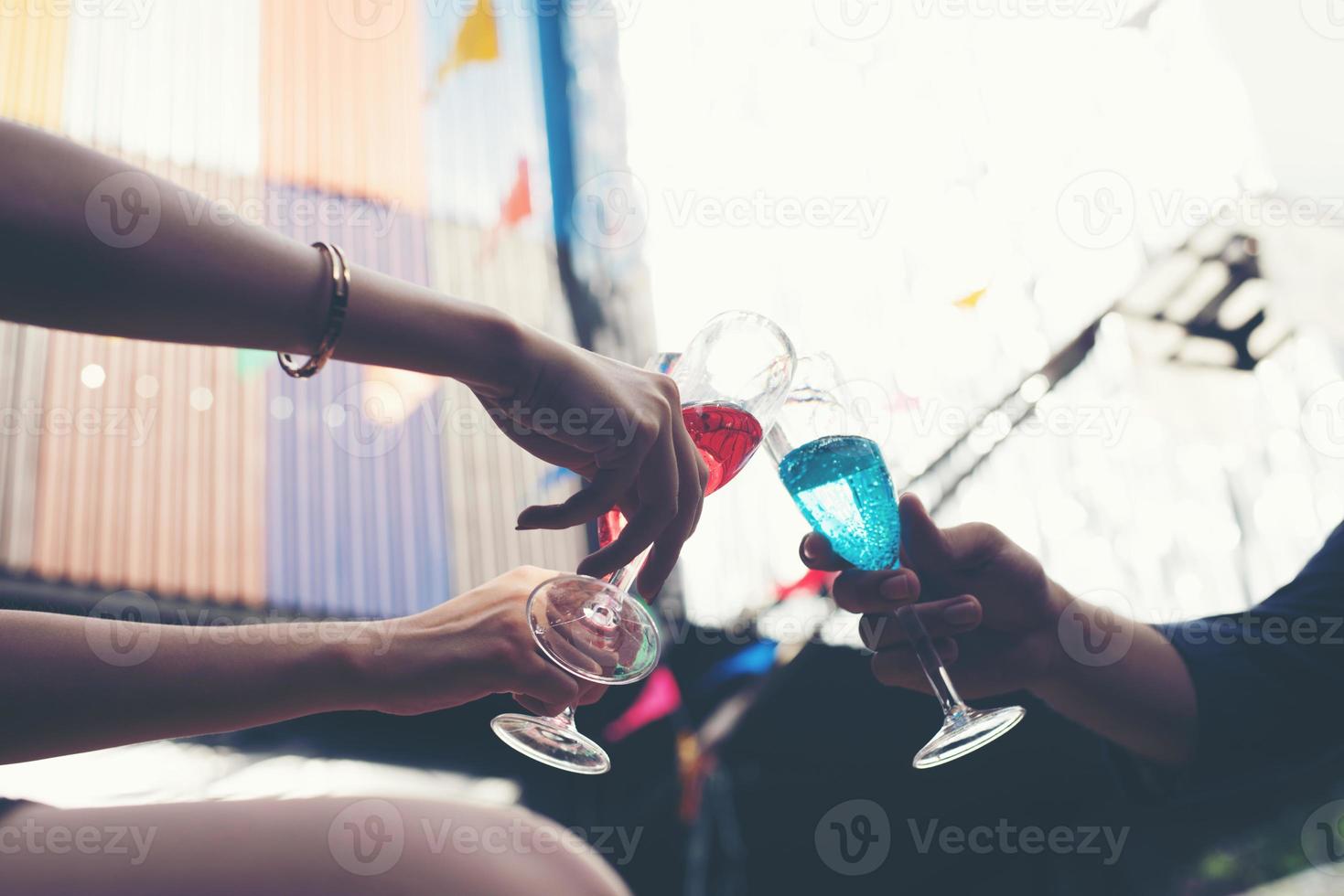 Portrait of happy young friends having fun and drinking together photo