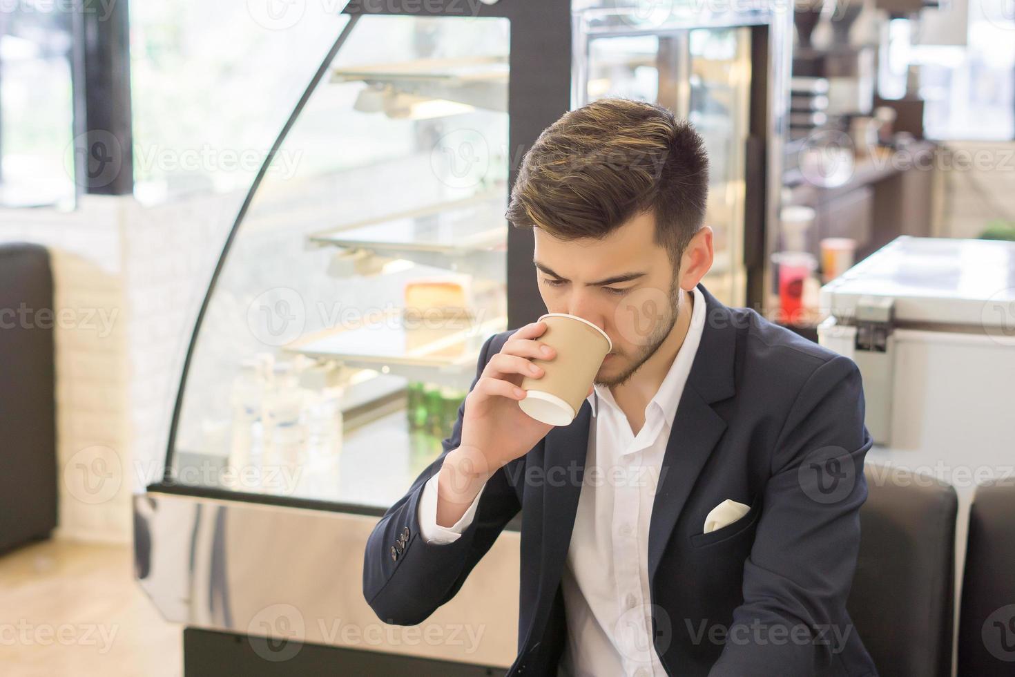 Young businessman drinking coffee photo