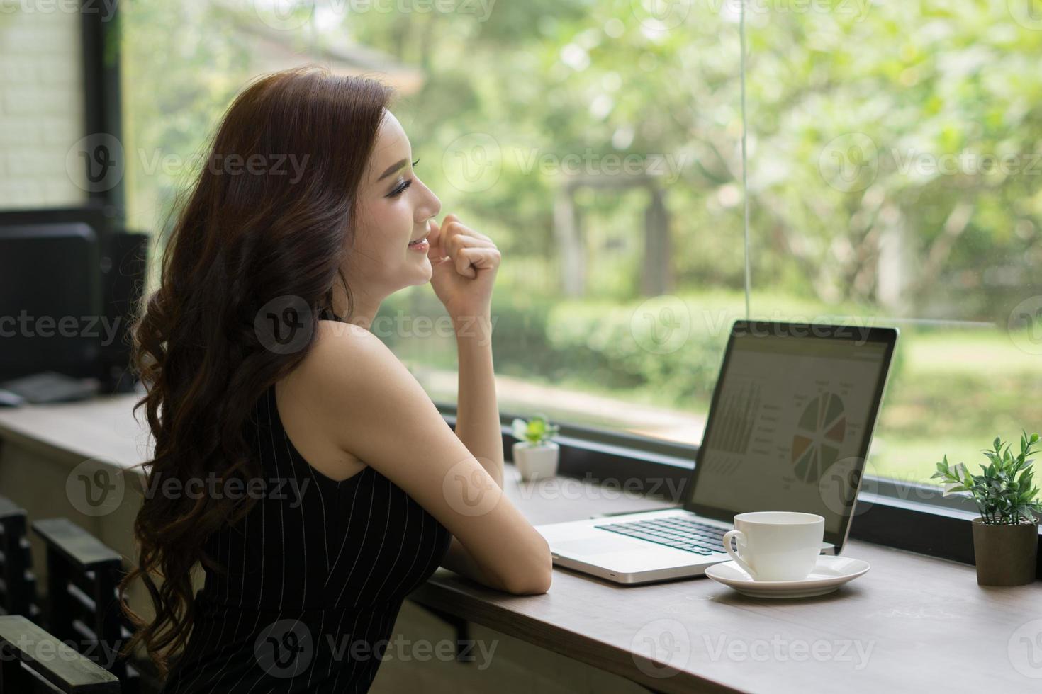 Young business woman working on laptop at office photo