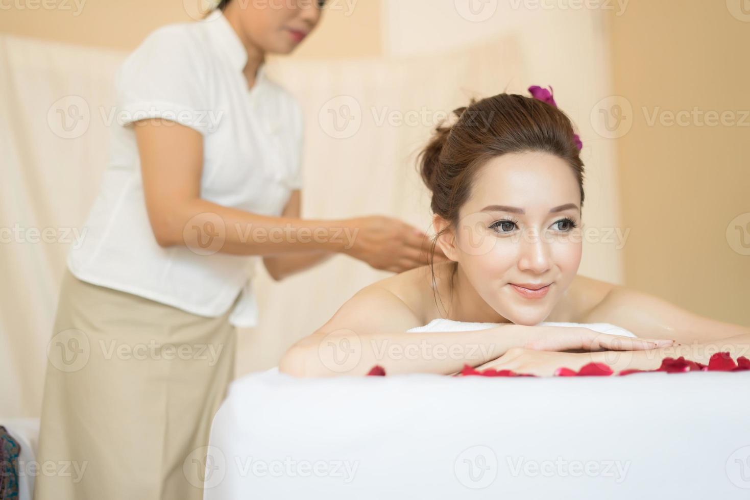 Young beautiful woman with healthy massage in a spa salon photo