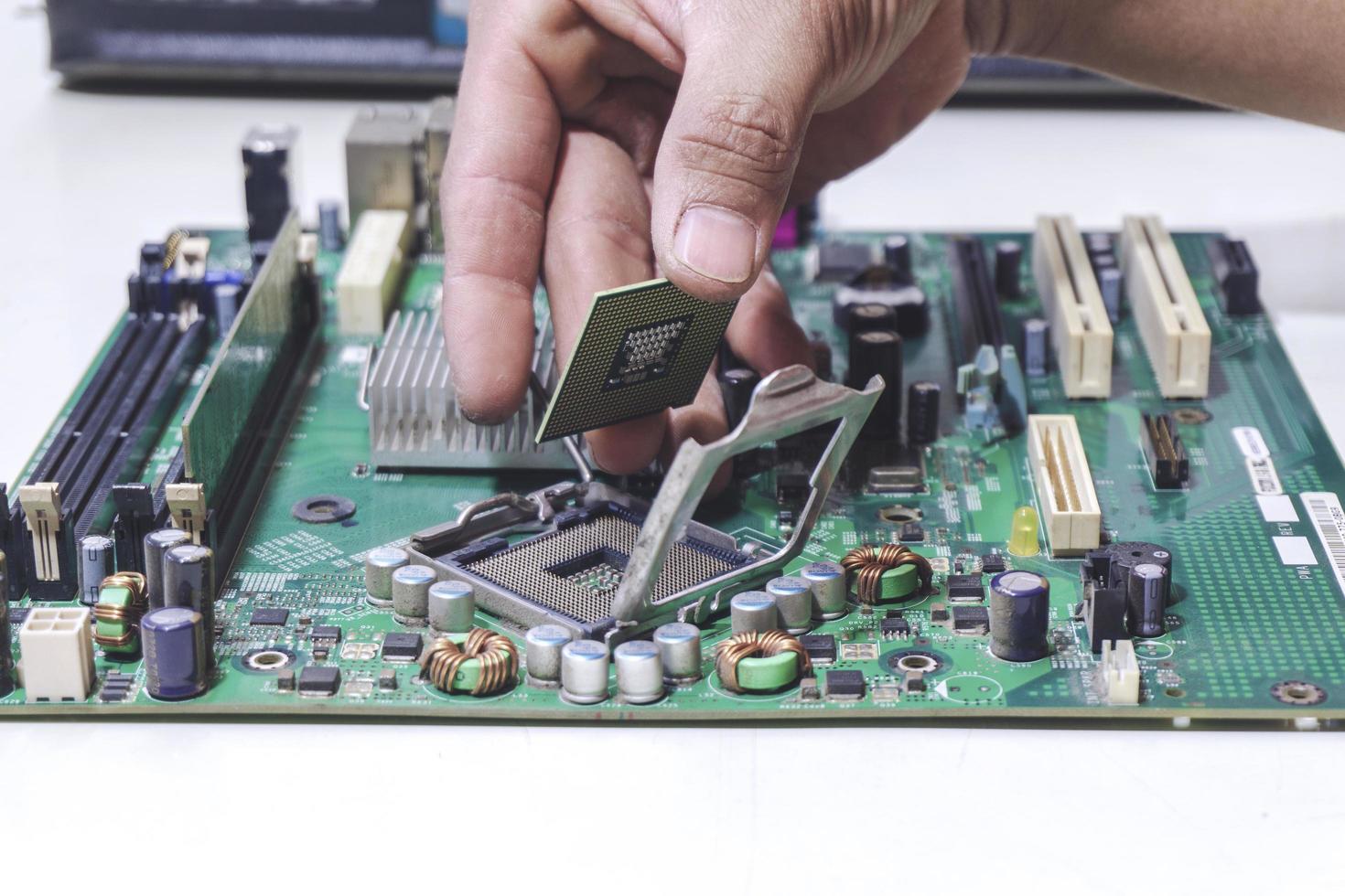 Technician hand holding the CPU for fixing and upgrade computer pc to repair photo